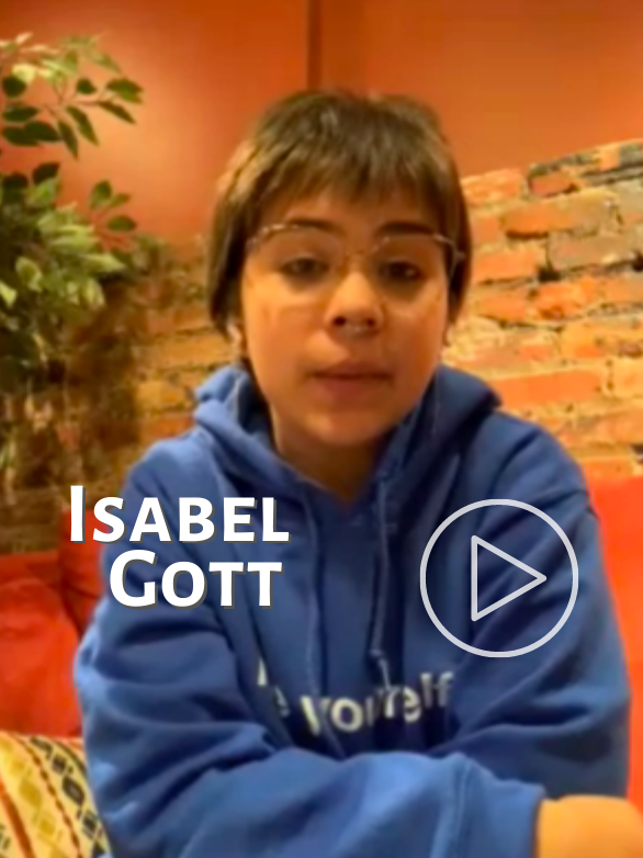 Link to Isabel Gott's interview. She stares gently into the camera with folded arms.